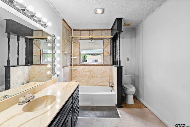 bathroom featuring toilet, ornamental molding, vanity, and a textured ceiling