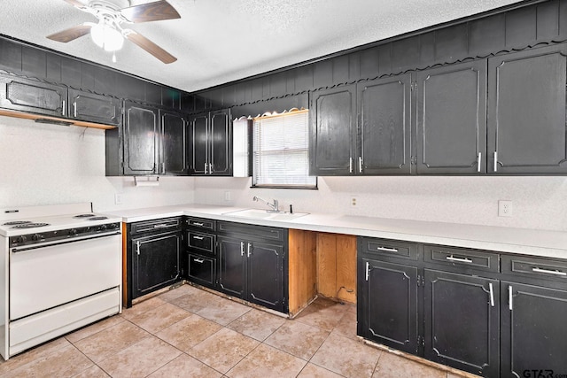 kitchen with white electric stove, a textured ceiling, dark cabinetry, and a sink