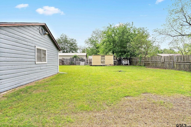 view of yard with a fenced backyard, an outdoor structure, and a storage shed