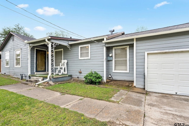 view of front of home with an attached garage and a front yard