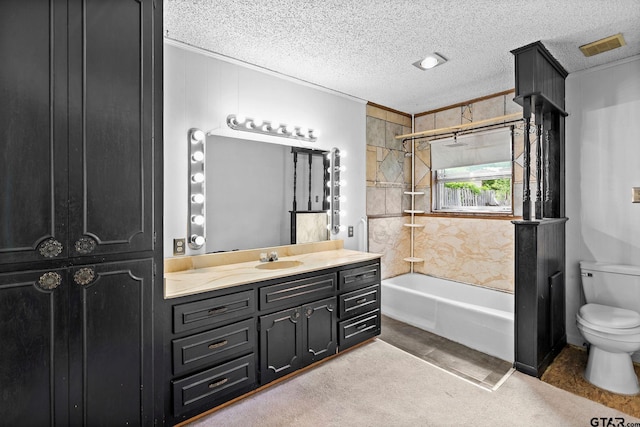 bathroom with a textured ceiling, vanity, washtub / shower combination, toilet, and ornamental molding