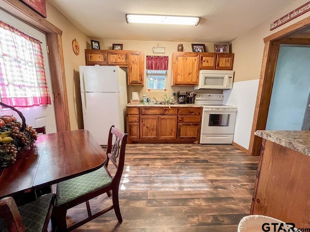 kitchen featuring dark hardwood / wood-style flooring and white appliances