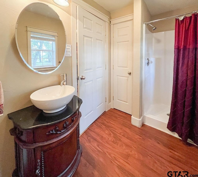 bathroom featuring vanity, hardwood / wood-style flooring, and a shower with shower curtain