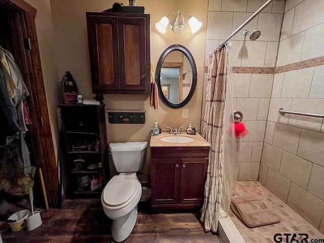 bathroom featuring hardwood / wood-style floors, vanity, toilet, and a shower with curtain