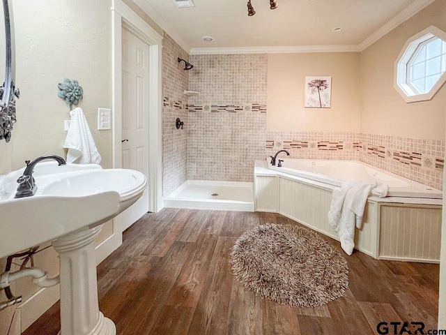 bathroom featuring shower with separate bathtub, sink, crown molding, and wood-type flooring