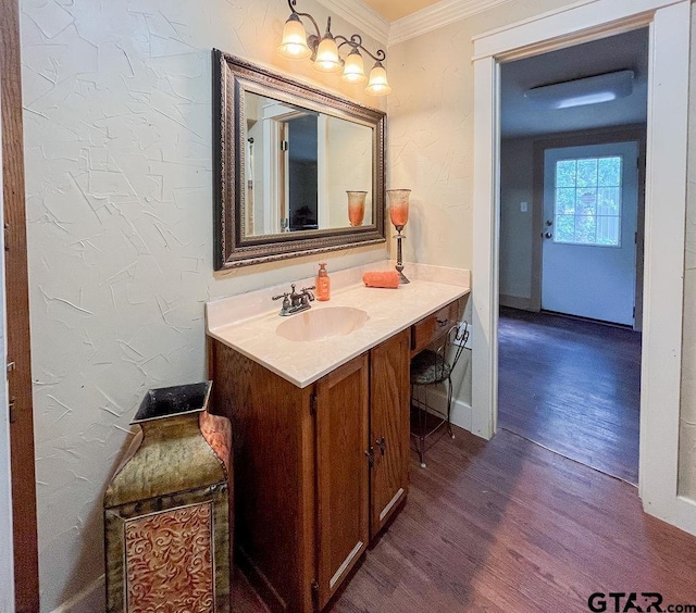 bathroom featuring wood-type flooring, vanity, and crown molding