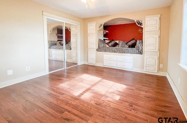 interior space featuring hardwood / wood-style flooring, ceiling fan, a textured ceiling, and a closet