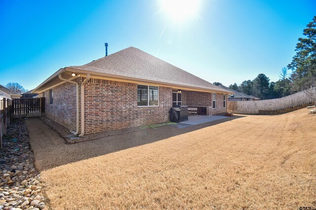 2222 Rana Park, Flint, TX 75762 - rear view of property featuring a fenced backyard, a patio, a shingled roof, and brick siding