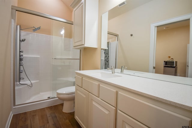 2222 Rana Park, Flint, TX 75762 - bathroom with visible vents, vanity, wood finished floors, toilet, and a stall shower