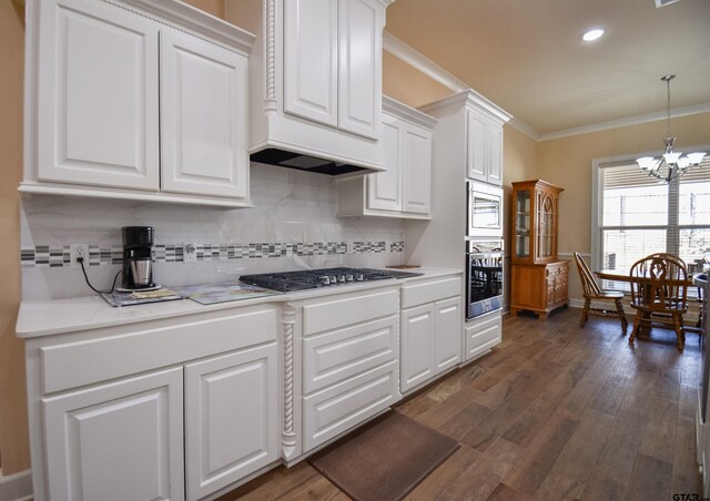 2222 Rana Park, Flint, TX 75762 - kitchen featuring backsplash, light countertops, white cabinets, a chandelier, and stainless steel appliances