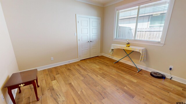 2222 Rana Park, Flint, TX 75762 - unfurnished bedroom featuring crown molding, baseboards, a closet, and light wood-type flooring