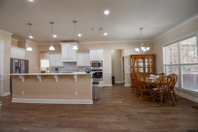 2222 Rana Park, Flint, TX 75762 - kitchen featuring ornamental molding, a kitchen bar, light countertops, white cabinetry, and appliances with stainless steel finishes