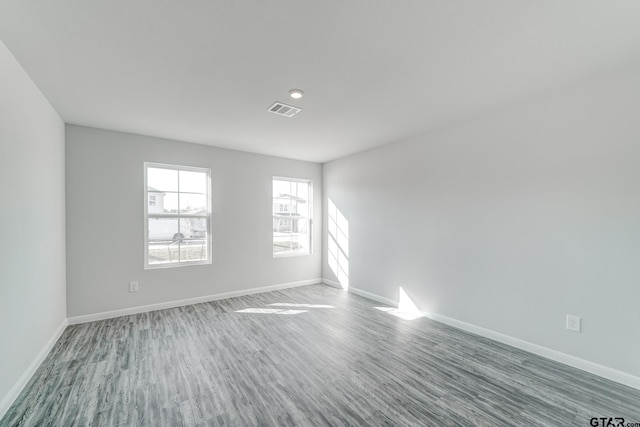 unfurnished room with wood-type flooring