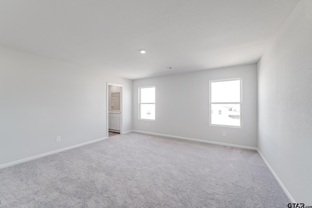 empty room featuring light carpet