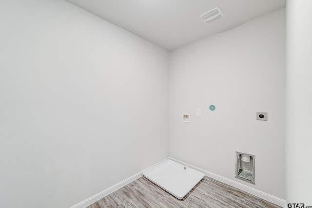 laundry area with hookup for a gas dryer, hookup for a washing machine, hookup for an electric dryer, and wood-type flooring