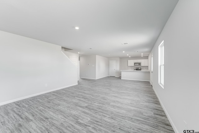 unfurnished living room with light wood-type flooring