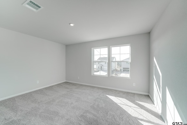 unfurnished room with light colored carpet