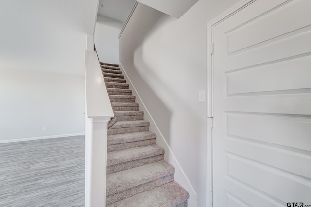 stairs with wood-type flooring