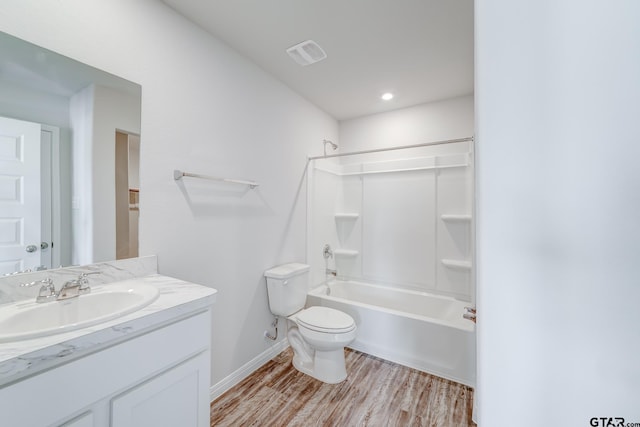 full bathroom with toilet, vanity, wood-type flooring, and bathing tub / shower combination