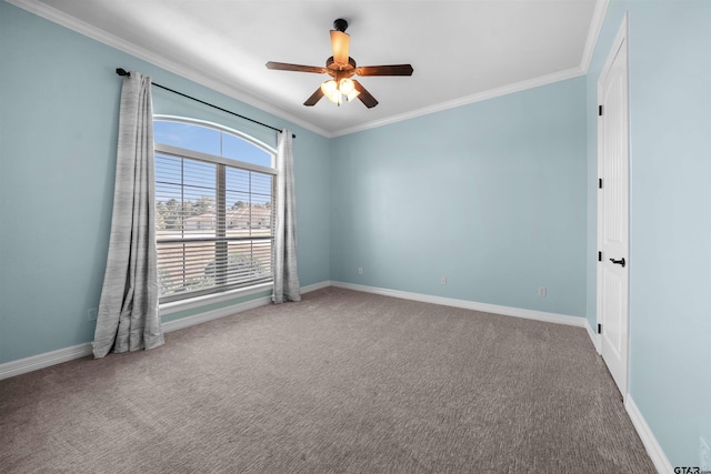 spare room featuring carpet, ceiling fan, and crown molding