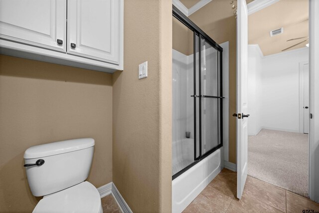 21882 Syrah Dr, Tyler, TX 75703 - bathroom with toilet, bath / shower combo with glass door, tile patterned floors, and baseboards