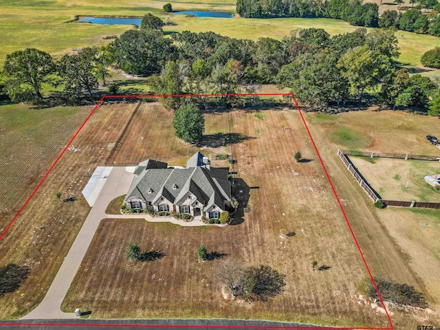 birds eye view of property featuring a rural view and a water view