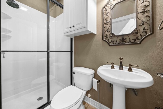 21882 Syrah Dr, Tyler, TX 75703 - full bathroom with a stall shower, toilet, baseboards, and a textured wall