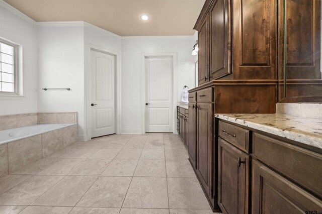 21882 Syrah Dr, Tyler, TX 75703 - kitchen featuring ornamental molding, dark brown cabinets, light tile patterned floors, light stone counters, and recessed lighting