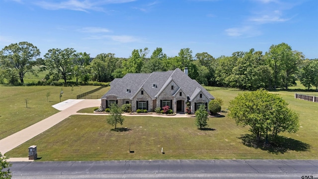 21882 Syrah Dr, Tyler, TX 75703 - french country inspired facade featuring stone siding, a front lawn, and driveway