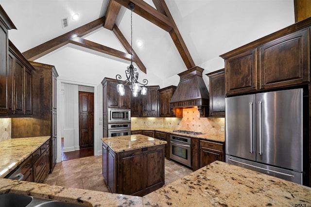 kitchen featuring stainless steel appliances, hanging light fixtures, high vaulted ceiling, backsplash, and premium range hood