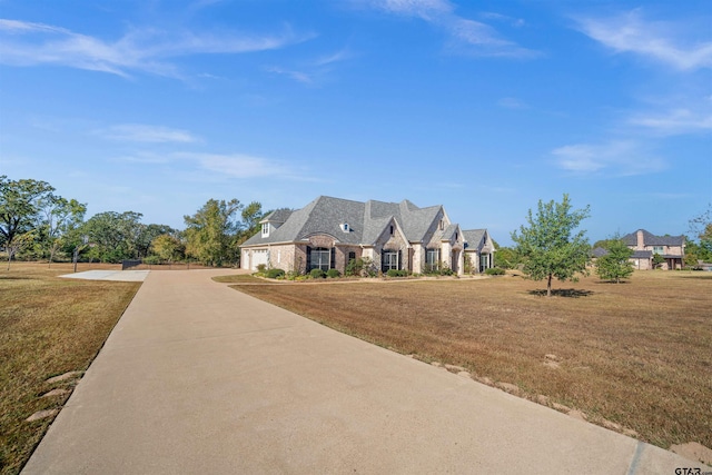 french country inspired facade with a front lawn