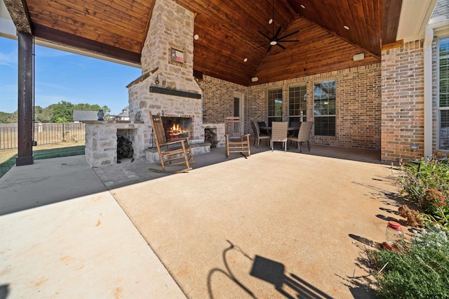 view of patio with ceiling fan and an outdoor stone fireplace