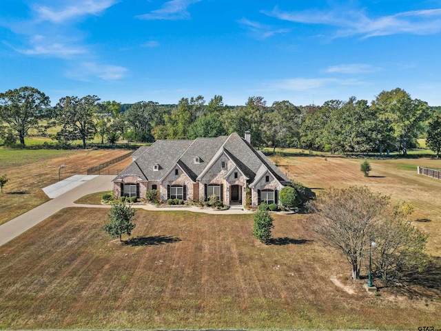 view of front of property with a front lawn and a rural view