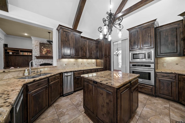 kitchen featuring decorative backsplash, sink, a chandelier, pendant lighting, and appliances with stainless steel finishes