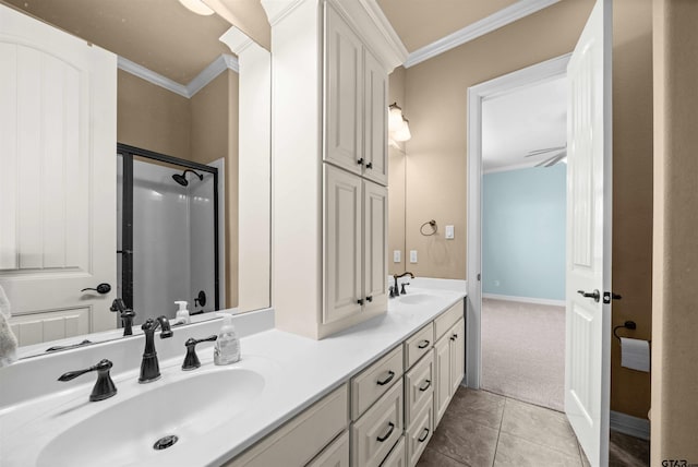 bathroom with ornamental molding, vanity, tile patterned flooring, ceiling fan, and a shower with shower door