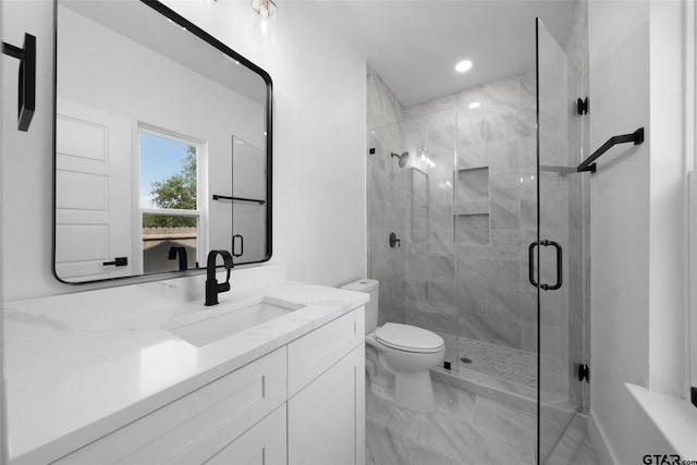 bathroom featuring toilet, vanity, and an enclosed shower