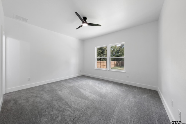 spare room featuring ceiling fan and carpet floors