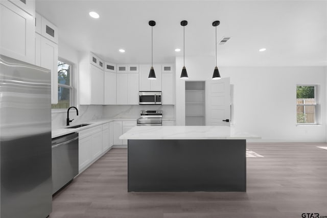 kitchen featuring a kitchen island, white cabinetry, and stainless steel appliances