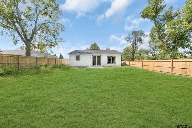 back of property with a patio area and a yard