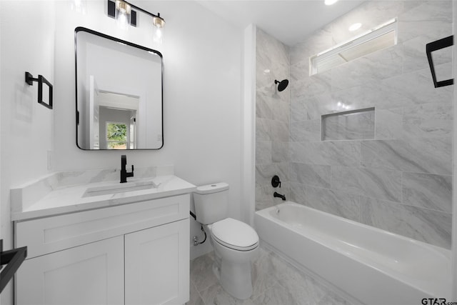 full bathroom with tiled shower / bath, toilet, and vanity