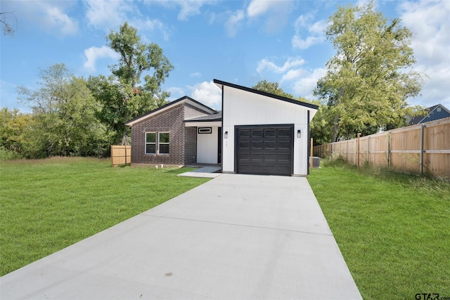 view of front of home with a garage and a front lawn