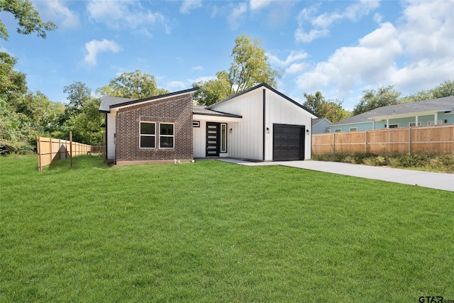 view of front of house with a garage and a front yard