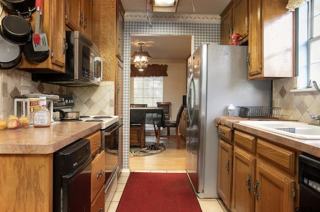 811 Janis, Bullard, TX 75757 - kitchen featuring stainless steel appliances, brown cabinetry, and plenty of natural light