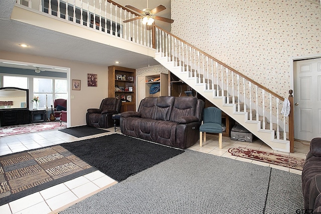 811 Janis, Bullard, TX 75757 - living area with ceiling fan, stairs, tile patterned floors, wallpapered walls, and a high ceiling