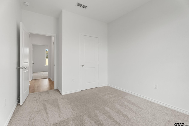 unfurnished bedroom with light carpet