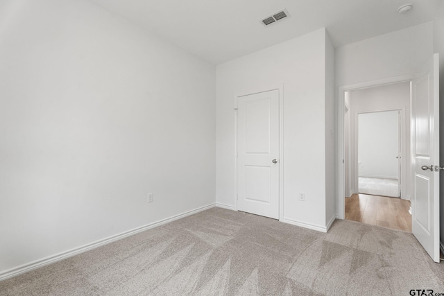 unfurnished bedroom with light carpet