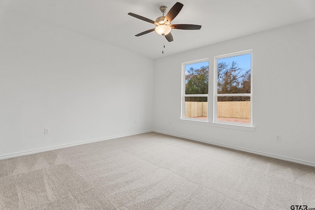 unfurnished room with ceiling fan and carpet flooring