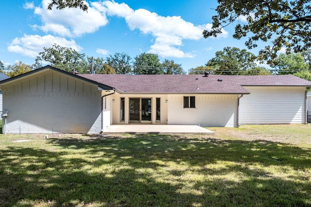 back of property featuring a lawn and a patio area