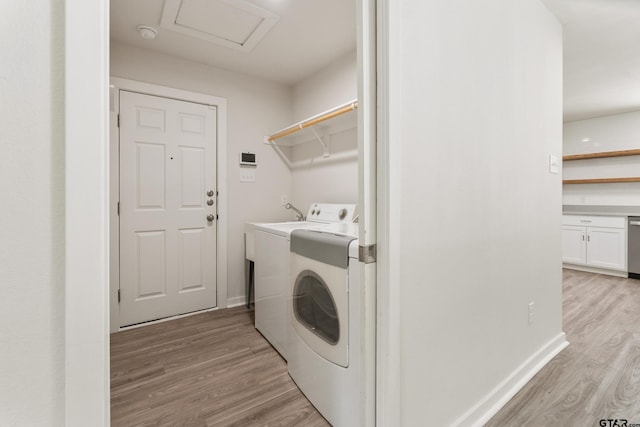 clothes washing area with light hardwood / wood-style floors and independent washer and dryer