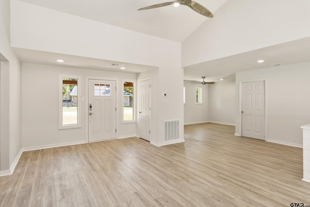 entrance foyer with ceiling fan, light wood-type flooring, and high vaulted ceiling